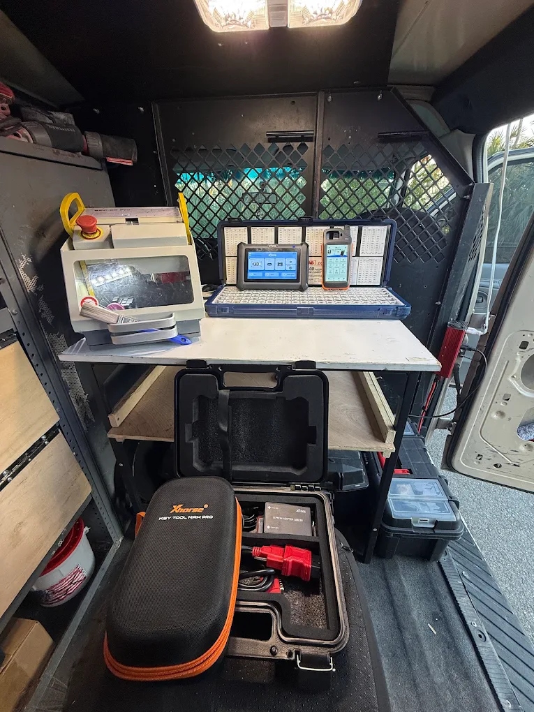 Inside mobile van equipped with Xhorse Key Tool Max Pro and key cutting workstation in North Port